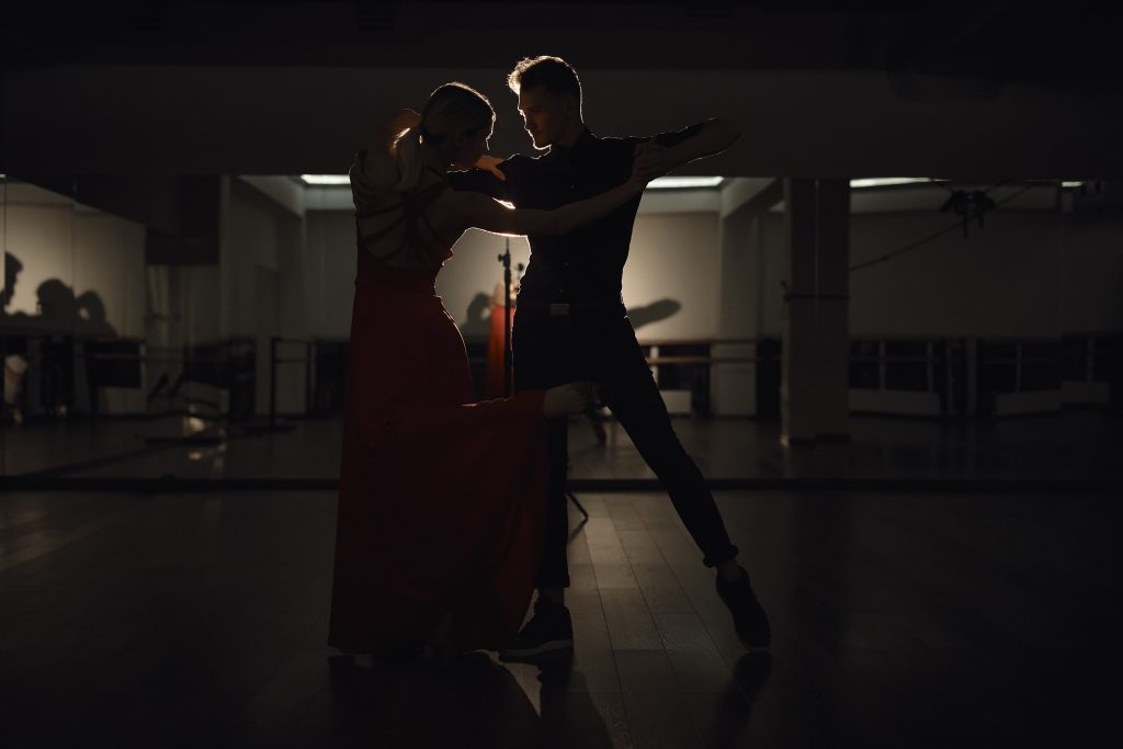 Young beautiful couple dancing with passion